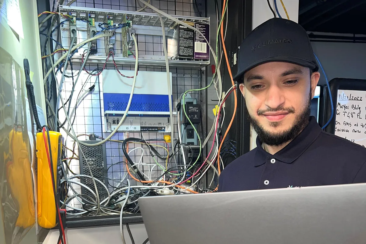 A trainee working with controllers and software.