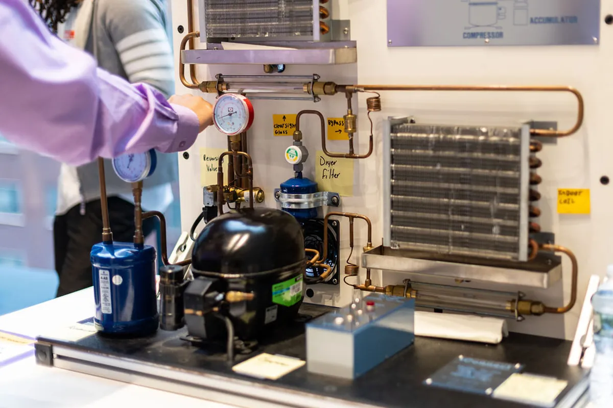 A trainee at a hands-on wiring station.