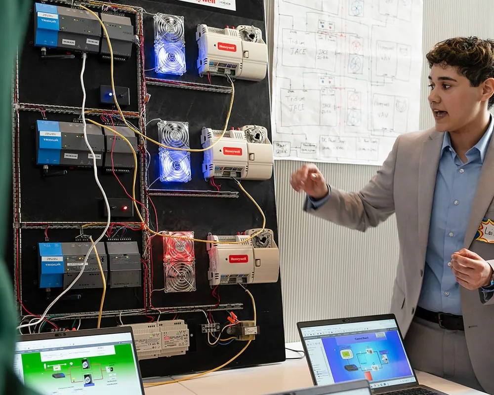 A Stacks+Joules graduate working on a building automation panel.